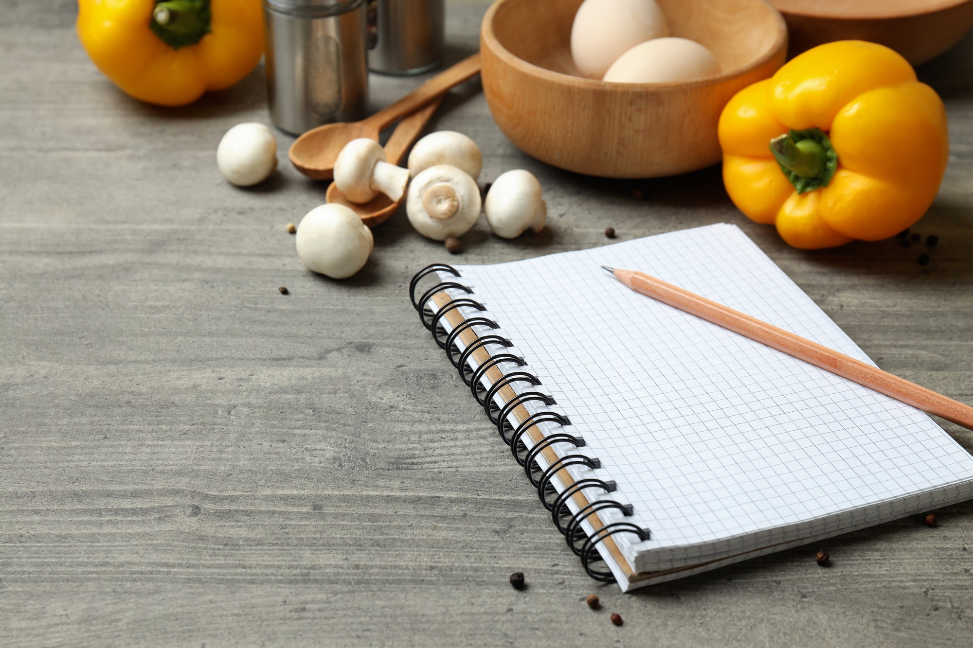 Studio kitchen table with fresh ingredients and a notebook