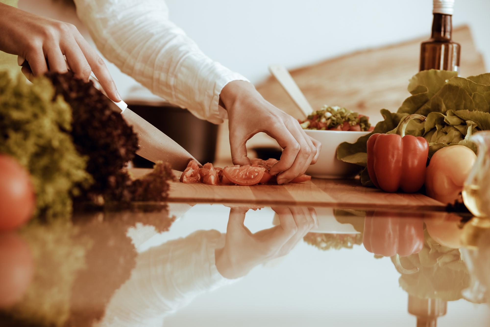 Cooking hands seasoning a pan